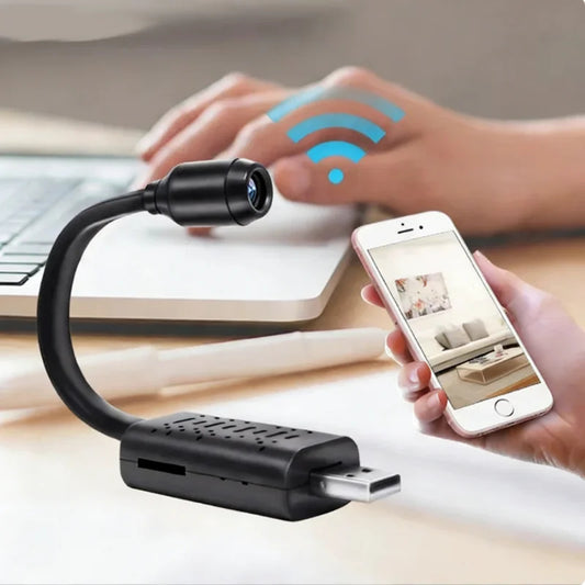 Black USB camera with flexible arm on a desk, connected to a smartphone displaying an app interface.